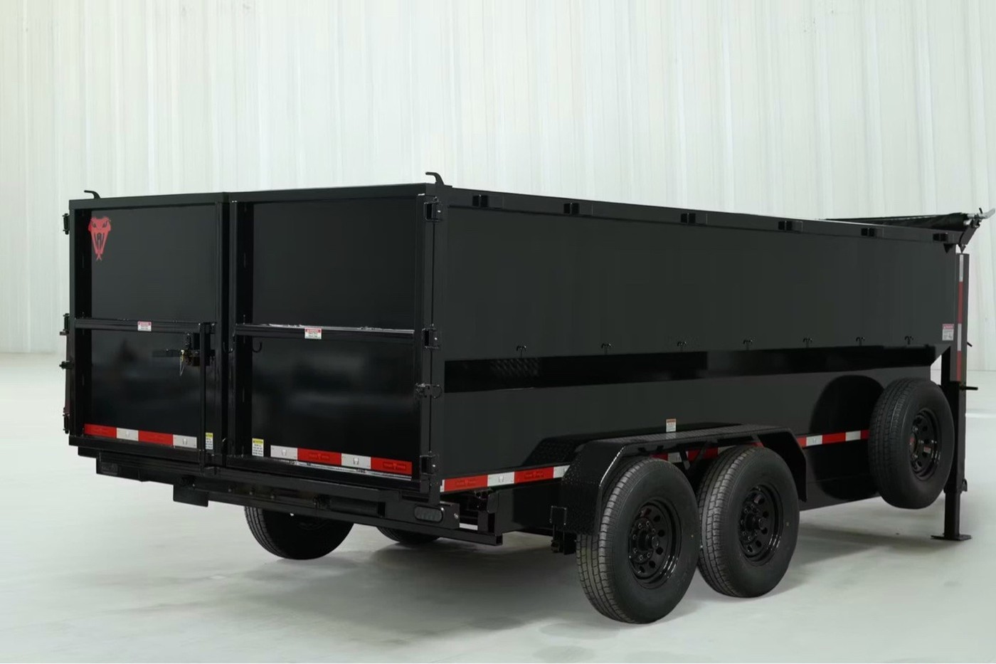 Rear three-quarter view of a black Texas Pride dump trailer.